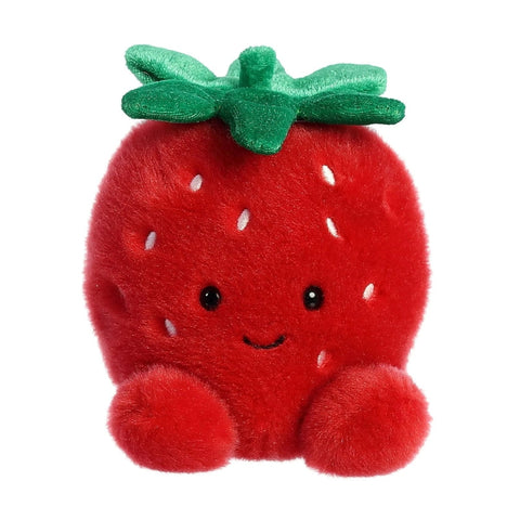 Plush strawberry toy with a smiling face on a white background