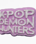 Purple and silver 'K-Pop Demon Hunters' text on a white background