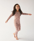 Young girl wearing a floral long-sleeve outfit on a white background