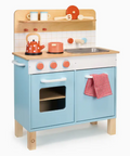 Children's wooden play kitchen with blue oven and wooden cabinets on a white background