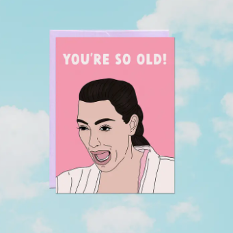 Card with a cartoon illustration of a woman and text 'You're so old!' on a pink background.