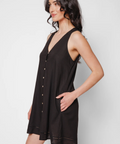 Woman wearing a black sleeveless dress against a white background