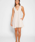 Woman wearing a beige sleeveless dress on a white background