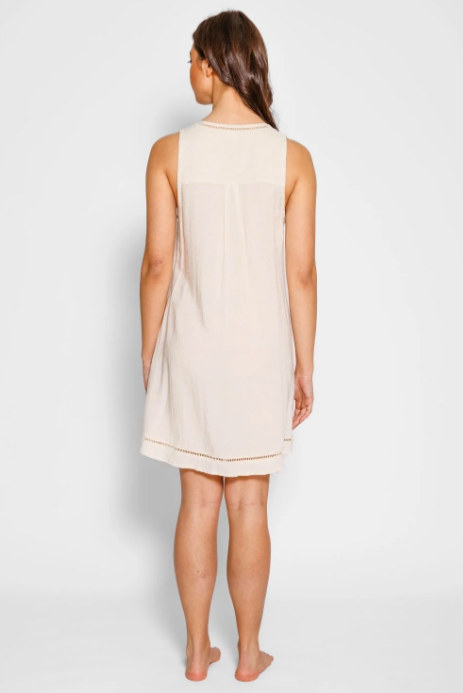 Woman wearing a beige sleeveless dress on a white background