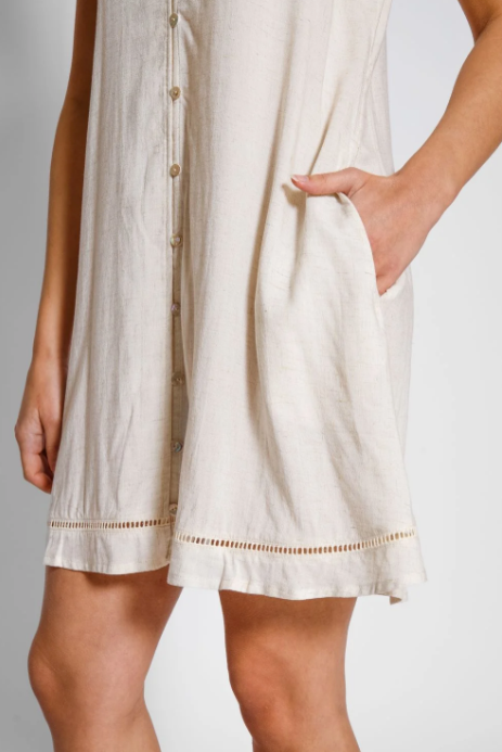 Beige dress with button details on a plain background