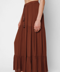 Brown tiered skirt worn by a person on a white background