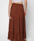 Brown tiered skirt worn by a person on a white background