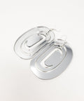 Large ovoid earrings from Copper Canoe Woman with trigon cutout in silver mirror acrylic.