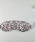Floral patterned sleep mask on a light gray background