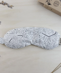 Sleep mask with floral pattern on a light surface with lavender flowers