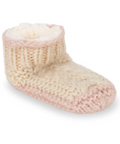 Knitted baby bootie with pink sole on a white background