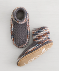 Pair of knitted baby boots with a brand logo on a light background
