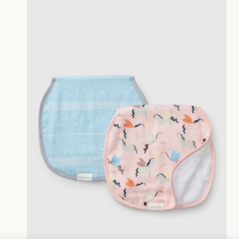 Two baby bibs, one blue with white polka dots and the other pink with colorful patterns, on a light gray background.