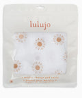 Lulujo muslin change pad cover packaging with sunflower design on a white background