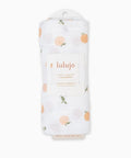 Lulujo baby swaddle with peach pattern on a white background