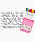 A children's coloring kit set on a white background, featuring a white alphabet tracing sheet with black outlines, six colorful markers (brown, green, pink, blue, purple, orange), and a translucent pink zippered case labeled 'cherrypick' and 'MINE COLORING KIT'.