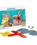 Makedo Deco-Props Sparkies toy set with its retail box and colorful wooden prop pieces on a white background. The set includes a variety of colored wooden shapes and connectors, with the packaging clearly showing the Makedo brand and product details.