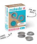 Makedo Roto-Ring set packaging box shown on a white background with three gray ring components placed in front. Arrows and text call out that it includes 16 pieces and is for all ages.
