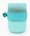A mint green Melii baby food storage container with a clear lid showing dry food inside, featuring a small soccer ball-shaped handle on the side.