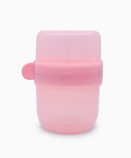 A translucent pink silicone baby bottle or feeding container with a matching pink screw-on cap and a small side tab, shown on a plain white background.