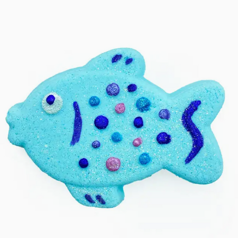 Blue fish-shaped bath bomb with colorful dots on a white background