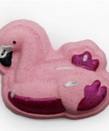 A pink flamingo-shaped bath bomb with glittery pink and deep magenta details, featuring a black beak and white eye, set against a plain white background.