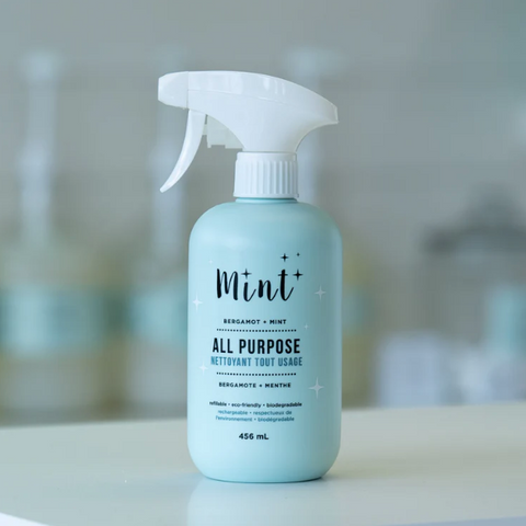 All-purpose cleaner bottle labeled 'Mint' on a blurred background