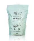 Mint-colored bath soak packaging with text on a white background