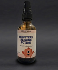 Bottle of 'Monsters Be Gone Potion' with a label on a dark background