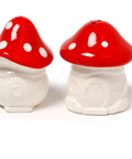 A pair of mushroom-shaped salt and pepper shakers with glossy red caps, white spots, and white textured bodies, shown on a plain white background.