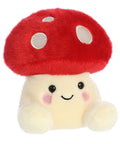 Plush toy with a red mushroom cap and a smiling face on a white background