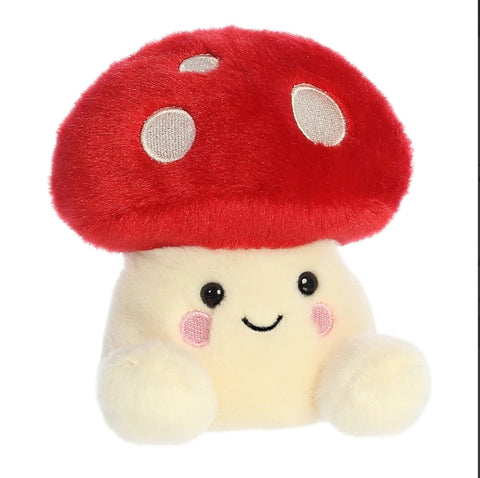 Plush toy with a red mushroom cap and a smiling face on a white background