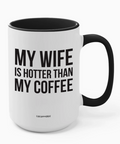 White mug with black interior and handle, featuring text 'My wife is hotter than my coffee' on a white background.
