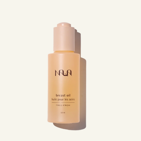 Nila breast oil bottle on a beige background