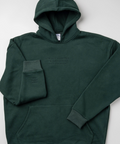 A dark forest green pullover hoodie with tonal embroidered text on the chest and sleeve, laid flat on a light gray background.