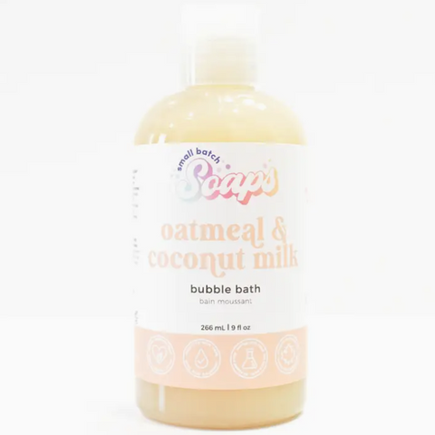 Bottle of oatmeal and coconut milk bubble bath with a white label on a white background