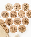 Set of wooden coasters with ocean-themed illustrations on a white background