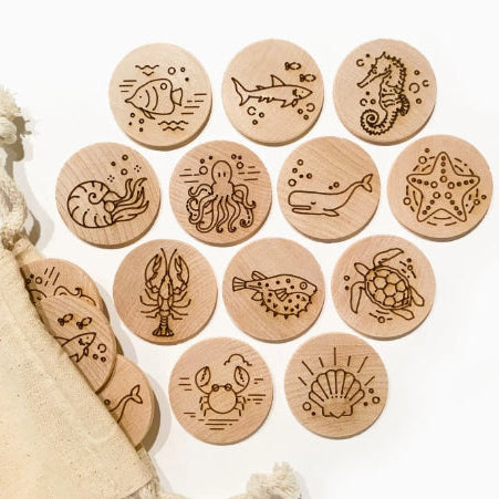 Set of wooden coasters with ocean-themed illustrations on a white background