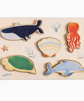 Wooden puzzle with sea-themed wooden animals on a white background
