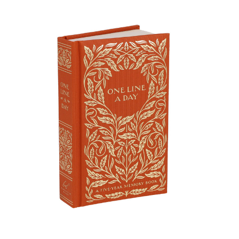 Red book with gold leaf design and 'One Line a Day' text on a white background