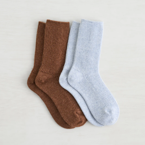 Two pairs of socks, one brown and one light blue, on a light gray background.
