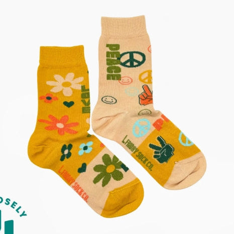 Two pairs of socks with floral and peace sign designs on a white background.