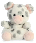 Plush toy cow with gray spots and pink accents on a white background