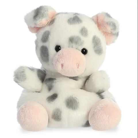 Plush toy cow with gray spots and pink accents on a white background