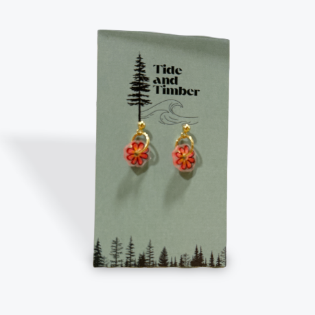 Flower-shaped earrings on a Tide and Timber branded card.