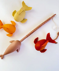 Set of colorful fish-shaped toys with a fishing rod on a white background