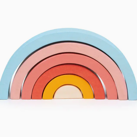 Set of colorful wooden rainbow toys on a white background