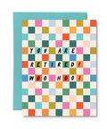 Colorful checkered card with退休! Woo Hoo! text and blue envelope on white background