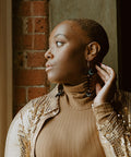 Model wearing the black acrylic Medium Salmon Ghost earring from Copper Canoe Woman.