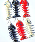 Medium Salmon Ghost earrings from Copper Canoe Woman in ivory, black, and red acrylic lay on a white background.
